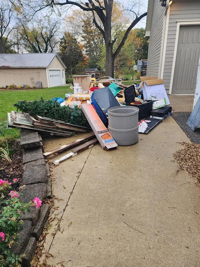 Dumpster being loaded with debris for 12 Yard Dumpster Rental in Bossier City